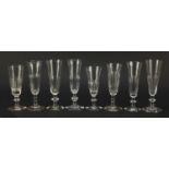 Eight 18th/19th century Champagne flutes with faceted bowls and knopped stems, the largest 17.5cm