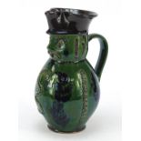 Green glazed pottery jug in the form of a Beefeater Toby jug, 24cm high : For Further Condition