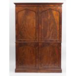 Early 19th century flame mahogany linen press fitted with a pair of panelled doors enclosing linen