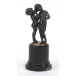 Classical silvered model of two nude children raised on a circular green marble base, 13cm high :