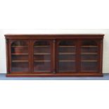 19th century mahogany low library bookcase fitted with two pairs of domed glazed doors enclosing
