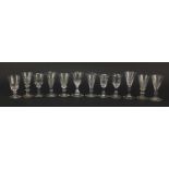 Twelve 18th/19th century facetted gin glasses, some with blade collars and knopped stems, the