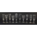 Ten 18th/19th century Champagne flutes including examples with faceted knopped stems and blade
