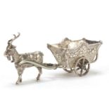 German silver model of goat pulling a cart with rotating wheels, impressed to the base, 11cm in