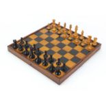 19th century mahogany ebony and boxwood folding chess board and a Staunton chess set with weighted