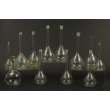 Twelve early 20th century glass Chemist's flasks or retorts, the largest each 32cm high : For