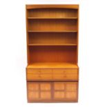 Nathan Furniture teak wall unit with open shelves above four drawers and a pair of cupboard doors,