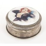 George V circular silver pill box and cover, Birmingham 1919, inset with an enamel panel decorated