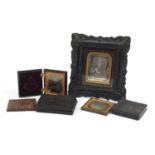 Three 19th century bois durci cases and a photo frame including one housing a hand coloured