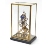 Gothic style brass skeleton clock with moon phase dial, housed under a glazed display case, 54.5cm H