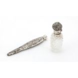 Victorian unmarked silver conical scent bottle and a cut glass example with hinged silver lid, the