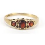 9ct gold garnet seven stone ring, size N, 1.5g : For Further Condition Reports, Please Visit Our