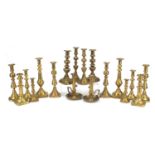 Nine pairs of 19th century and later brass candlesticks including a pair with drip trays, the