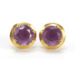 Pair of 14ct gold solitaire stud earrings, possibly alexandrite, 1cm in diameter, 2.8g : For Further