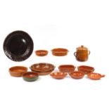 Earthenware and terracotta bowls including a treacle glazed platter and two Portuguese terracotta
