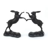 Pair of patinated bronze boxing hares raised on a shaped marble basees, 27cm high : For Further