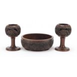 African carved wood fruit bowl and two similar candlesticks, the bowl 24cm in diameter : For Further