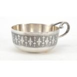 Silver coloured metal wine porringer embossed with a religious scene by E Dropsy, 10.5cm wide :