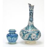 Turkish Iznik pottery vase and water jug hand painted with flower heads amongst scrolling foliage,