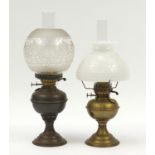 Two brass oil lamps with glass shades including one etched with flowers : For Further Condition
