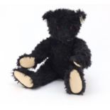 Large black Steiff bear with articulated limbs and glass bead eyes, numbered 406829, 48cm high : For