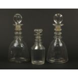 Pair of Georgian glass mallet form decanters with target stoppers and an Irish example, the pair