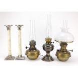 Pair of bone mounted candlesticks and three oil lamps including one with opaque glass shade, the