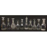 Ten Georgian cut glass decanters including two with mushroom stoppers, the largest 28cm high : For