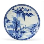 Japanese blue and white porcelain charger, hand painted with two figures crossing a bridge in a