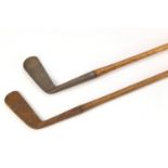 Two wooden shafted putters including one by H E Pearse, the largest 89cm in length : For Further