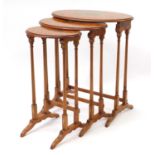 Nest of three Sheraton revival satinwood occasional tables hand painted with instruments and Putti