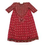 Central Asian Suzani silk woven ceremonial dress, detailed with flowers onto a red ground and coin