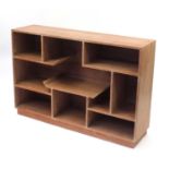 Art Deco lined oak display unit of various shelves and compartments raised on rectangular plinth