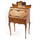 French oak writing bureau, having mirrored top rail above a fall enclosing a fitted interior on
