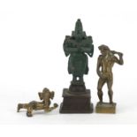 Two Indian bronzed metal figures and one of a nude male holding a club, the largest 12cm high :