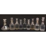 Nine Georgian cut glass decanters including a pair and a ship's decanter, the largest 28.5cm