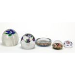 Four 19th century and later glass paperweights and a Pirelli millefiori dish, one paperweight with
