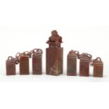 Set of seven Chinese carved soapstone seals with calligraphy, some on chain, the largest carved with