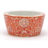 Chinese porcelain brush pot hand painted in iron red with flower heads amongst scrolling foliage,