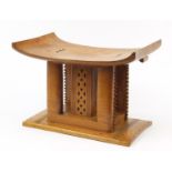 Large tribal interest carved hardwood head rest design seat, 40cm high x 57cm wide : For Further