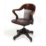 Mahogany revolving desk chair with slatted back and leather upholstered seat, 87cm high : For