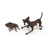 Two Japanese patinated bronze models of a standing dog bearing character marks to the base, together