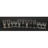 Twelve 18th/19th century dram glasses including five etched with flowers, the largest 10cm high :