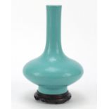 Chinese porcelain vase having a turquoise glaze, raised on carved hardwood stand, six figure
