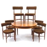Circular G Plan teak extending dining table with folding leaf and six chairs, the table 74cm high