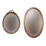 Two oval bevel edged wall mirrors comprising Edwardian inlaid mahogany and an ornate gilt framed
