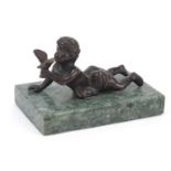 Patinated bronze figure of a young boy holding a bird raised on a square green marble base, 13cm