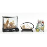 Two Chinese cork dioramas and a hand painted porcelain Buddha with five children, the largest 15.5cm