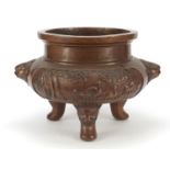 Large Chinese patinated bronze tripod censer with animalia handles and panels of animals in