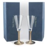 Pair of silver and glass champagne flutes by Theo Fennell, Birmingham 1989, with boxes, 21cm high,